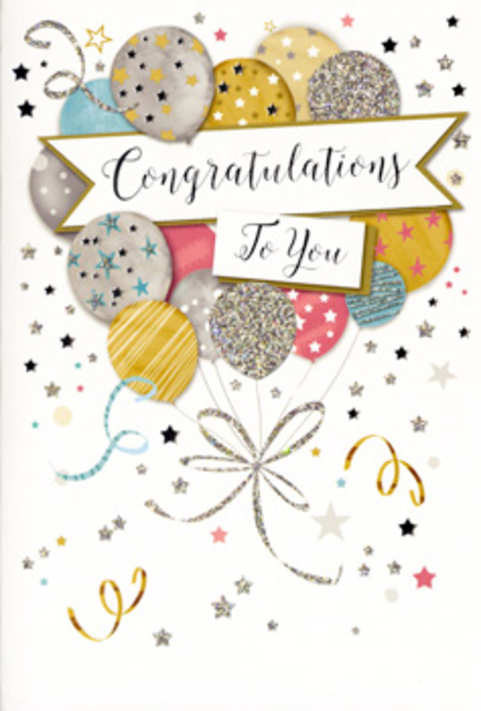 The photograph captures a sophisticated congratulations card whose design feels perfectly suited to life's proudest moments in Hornchurch. The central image is a cluster of airy balloons, rising as if freshly released at a joyous gathering near Langtons Gardens. The balloons are drawn with rounded, generous shapes and layered so they overlap gently without losing their individuality. Their colours form a refined, celebratory palette: muted gold, polished silver, soft champagne, clear sky blue, tender blush pink, and understated grey. Each balloon features a subtle decorative motif-tiny twinkling stars scattered like distant lights, fine vertical or diagonal stripes, or gently speckled patterns that resemble glitter dust. These intricate details lend the composition an almost tactile richness, suggesting different textures while remaining elegantly flat on the card. From the base of the balloon cluster, delicate ribbons in shimmering gold and silver cascade downward, sweeping in loose curls and loops that echo the playful movement of real ribbons in motion. Surrounding the balloons, small metallic stars, dots, and swirl-like flourishes are scattered across a pale, creamy background, giving the illusion of confetti hanging in the air mid-celebration. Cutting gracefully through the centre is a soft, flowing banner carrying the words Congratulations To You in ornate, calligraphic lettering that combines formality with heartfelt warmth. The suggestion of foil accents hints at a subtle shine when the card catches the light, similar to the premium finishes favoured for special greeting cards tucked beside luxury floral arrangements delivered across Hornchurch. The overall effect is one of poised festivity and genuine admiration, making this card an ideal companion to flowers when celebrating graduations, promotions, exam successes, or any cherished milestone worth remembering in the RM11 and RM12 neighbourhoods.